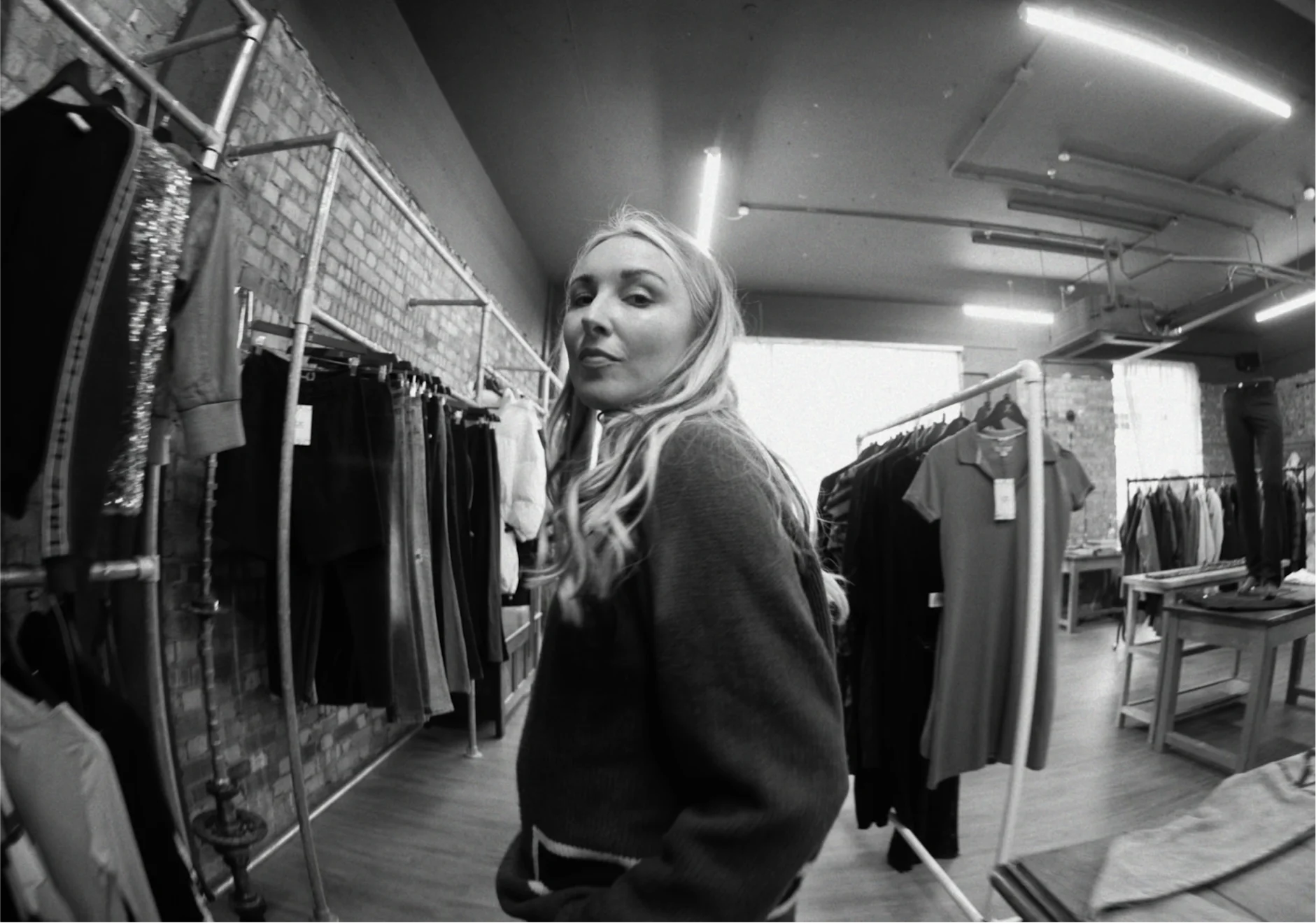 Kitty walking through a clothing shop, capturing style inspirations for her content on fashion trends and alt sneakers.