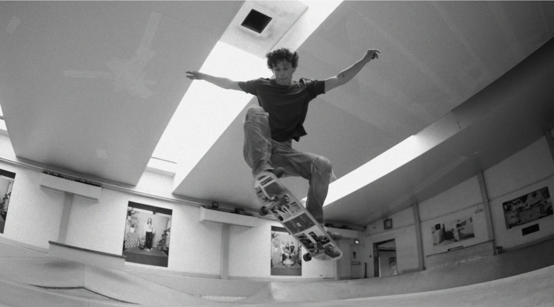 Lucien performing a skateboarding trick in a black-and-white photo, showcasing his passion for action and movement.